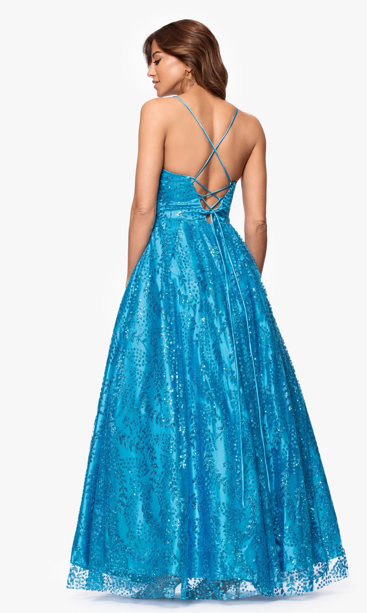 Woman wearing the Long Glitter Prom Dress Blondie Nites 4617BN—a blue, floor-length sequin A-line gown with a corset-style bodice, lace-up back, and thin straps—posing with her back to the camera.